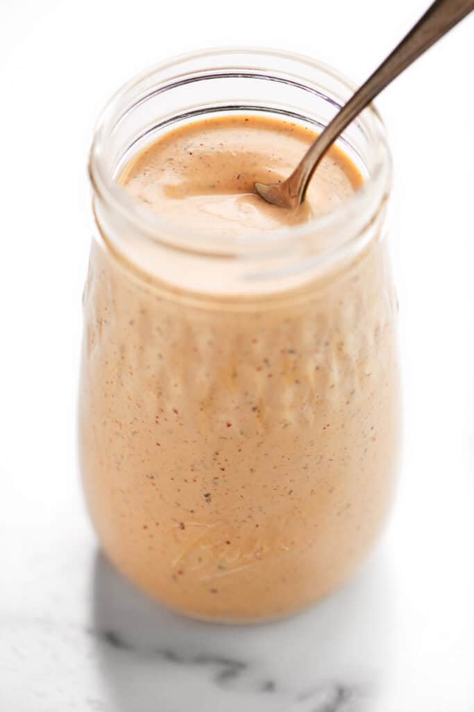 a spoon in a jar of chipotle ranch dressing