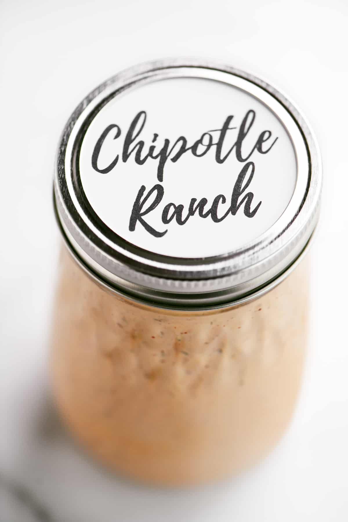 a jar of dressing with a homemade label on top
