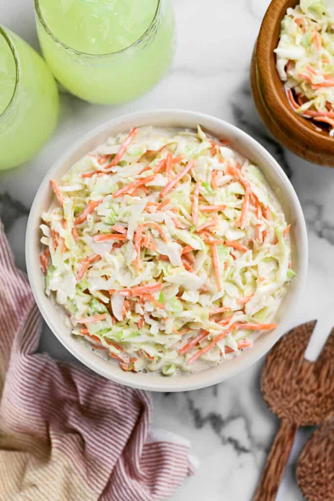 a bowl of coleslaw on a countertop