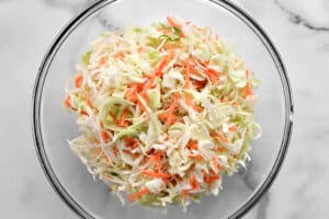 ingredients for coleslaw in a glass bowl