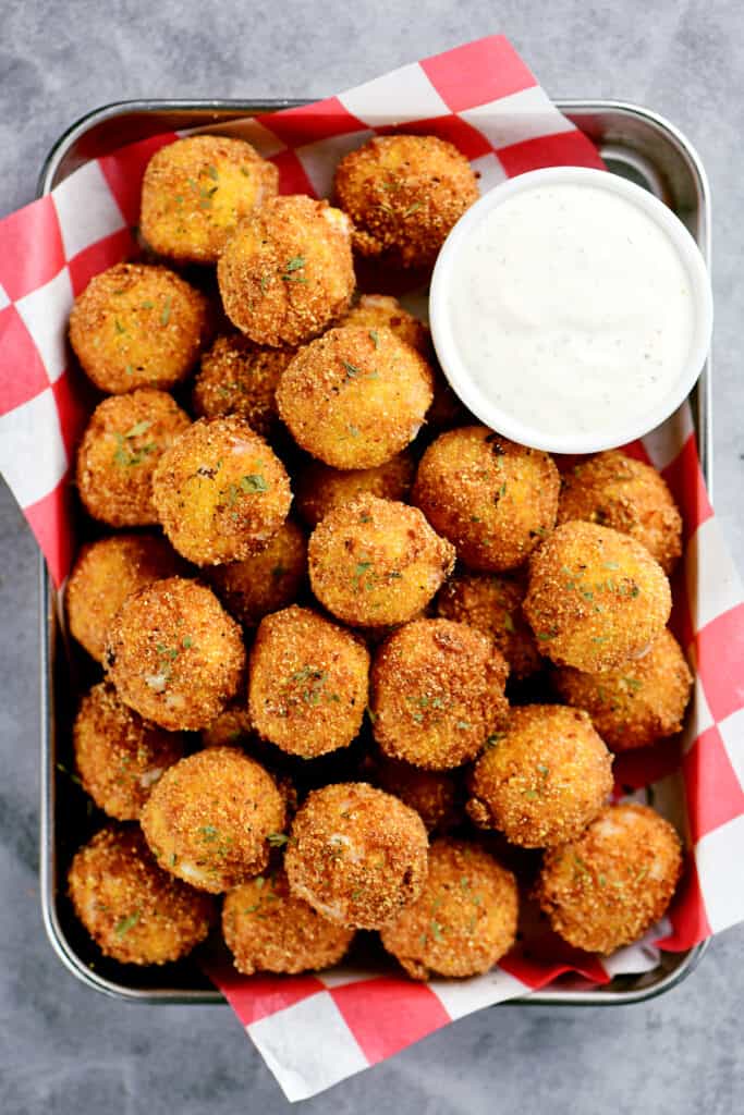 fired balls with corn and cream cheese inside adorned on a tray