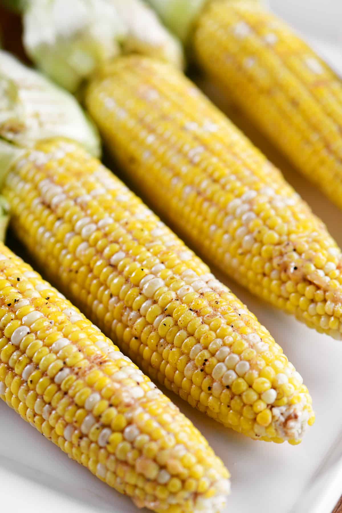 four cobs of corn on a plate