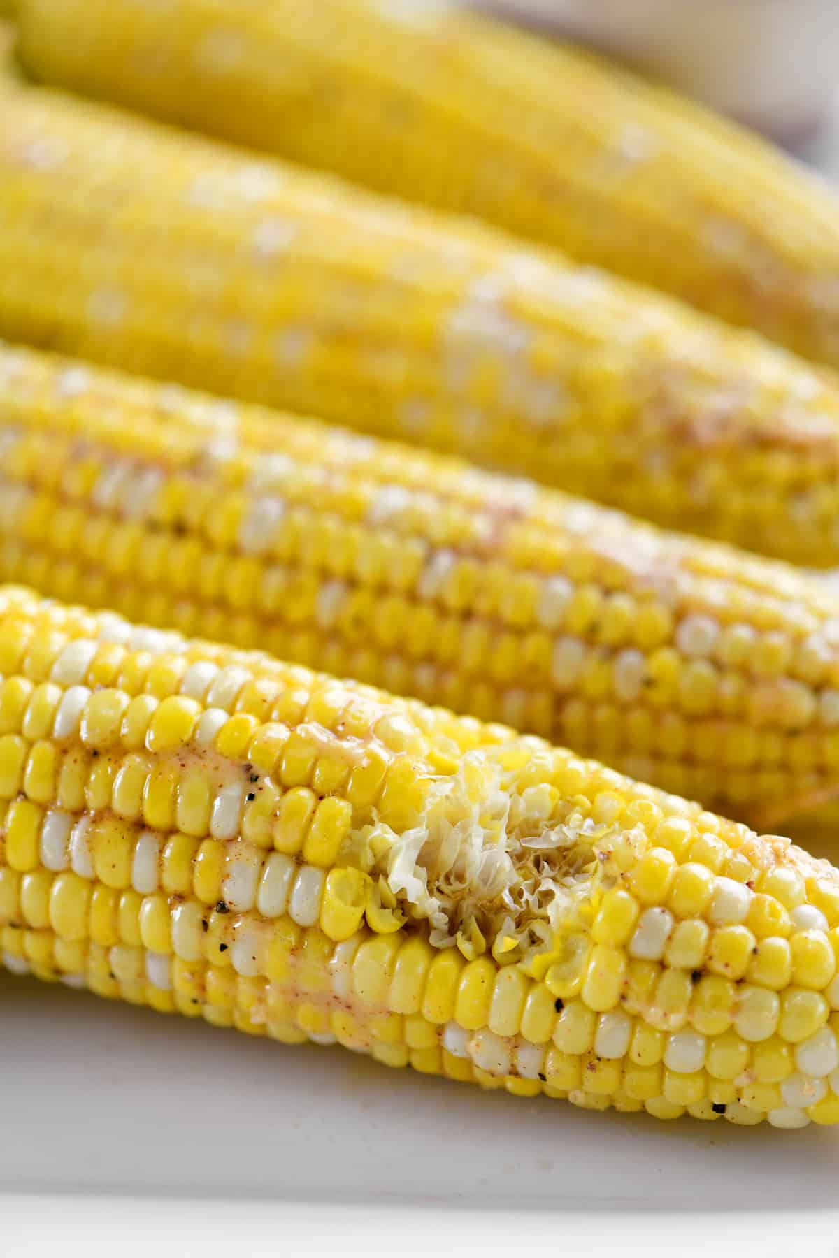 a cob of corn with a bite out of it