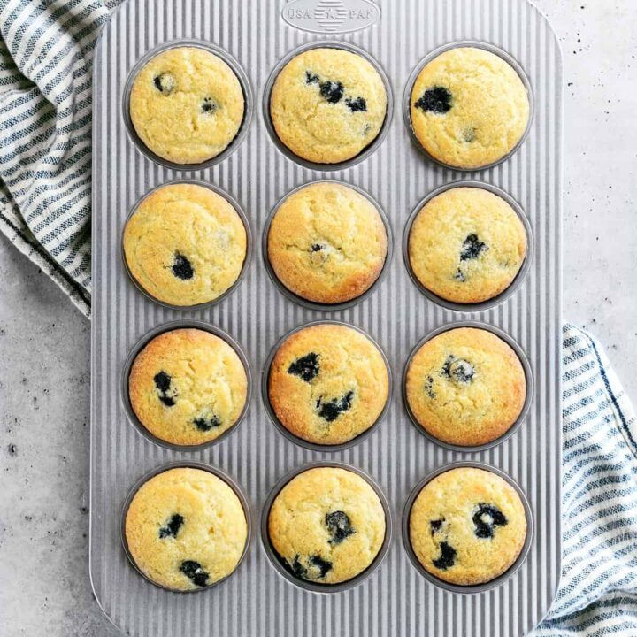 twelve blueberry muffins in a pan