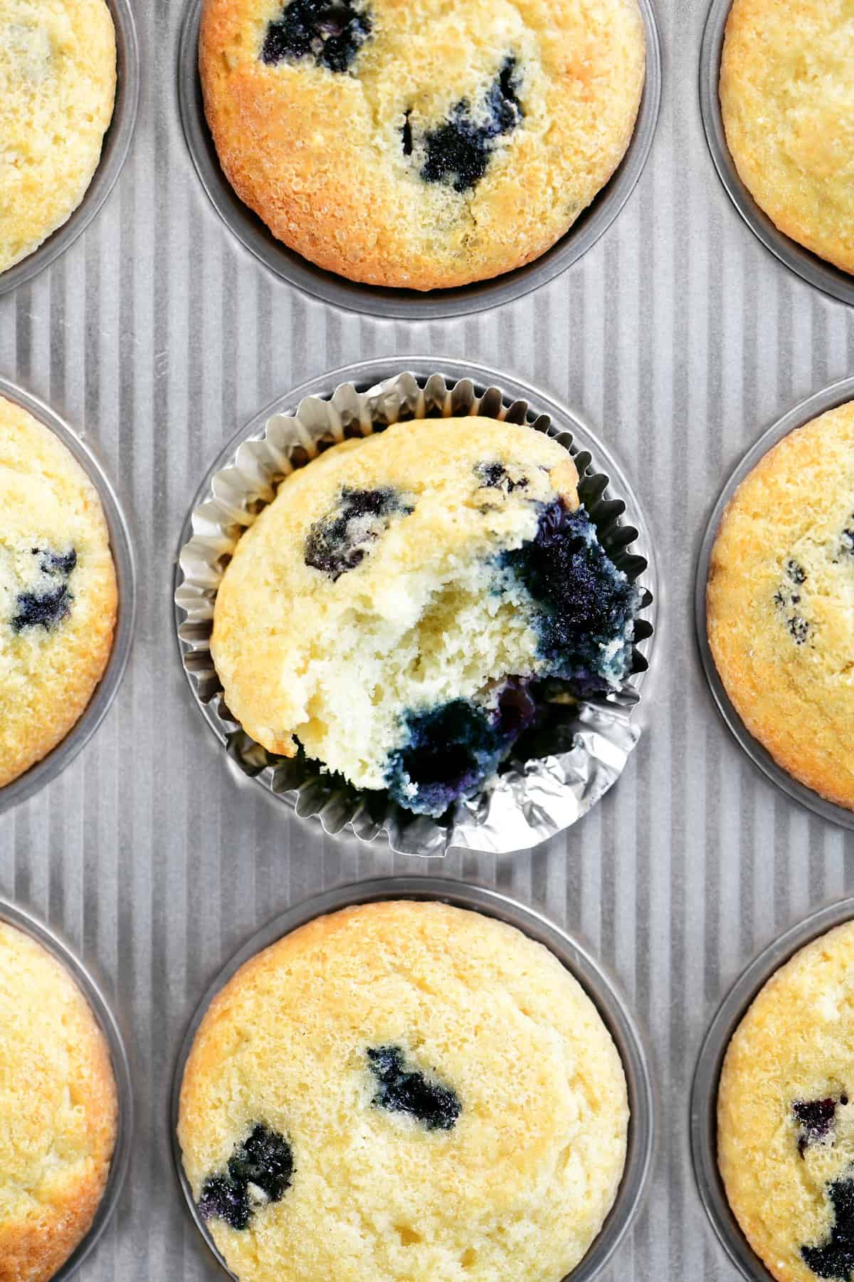 a blueberry muffin with a bite out of it