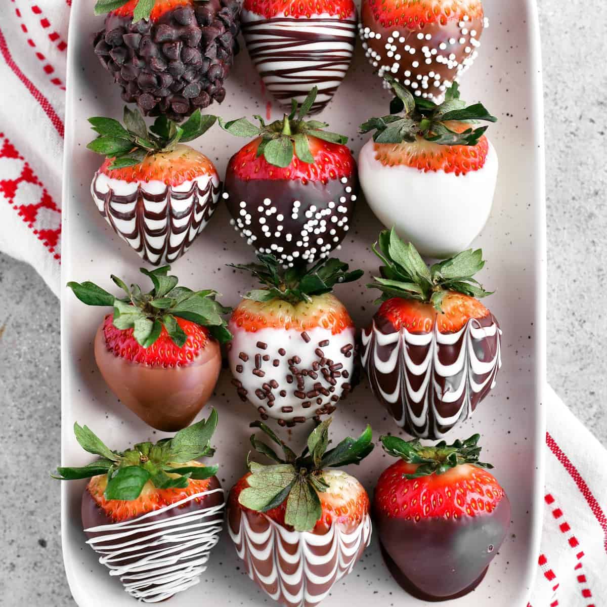 chocolate covered strawberries on a white tray