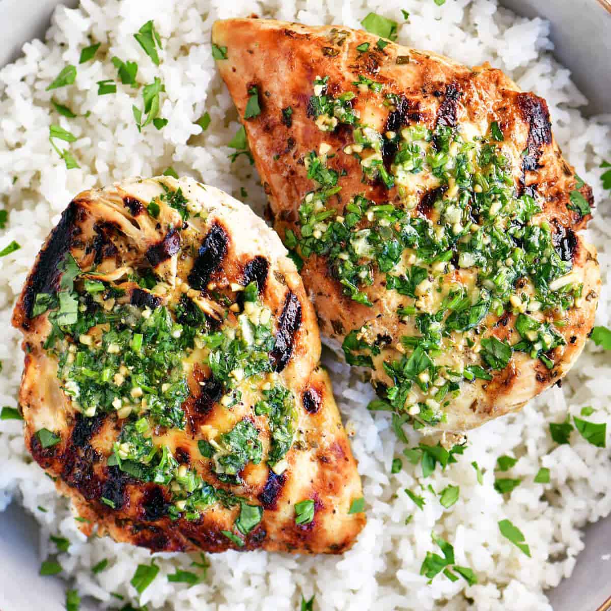 two cilantro lime chicken breasts on a bed of rice
