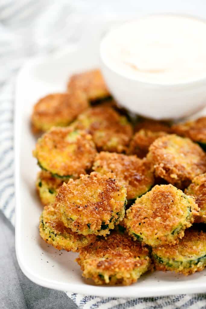 breaded fried summer squash slices on a tray