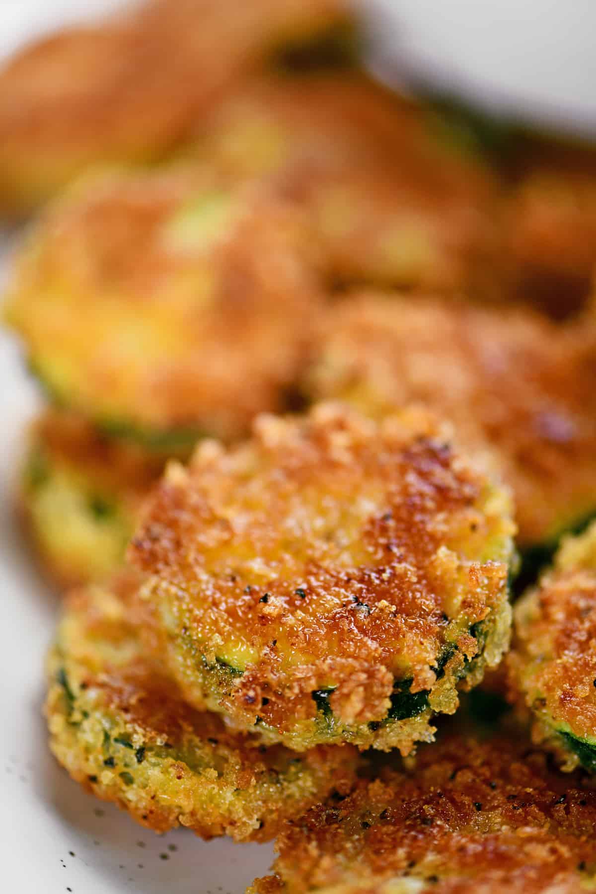 breaded zucchini rounds on a plate