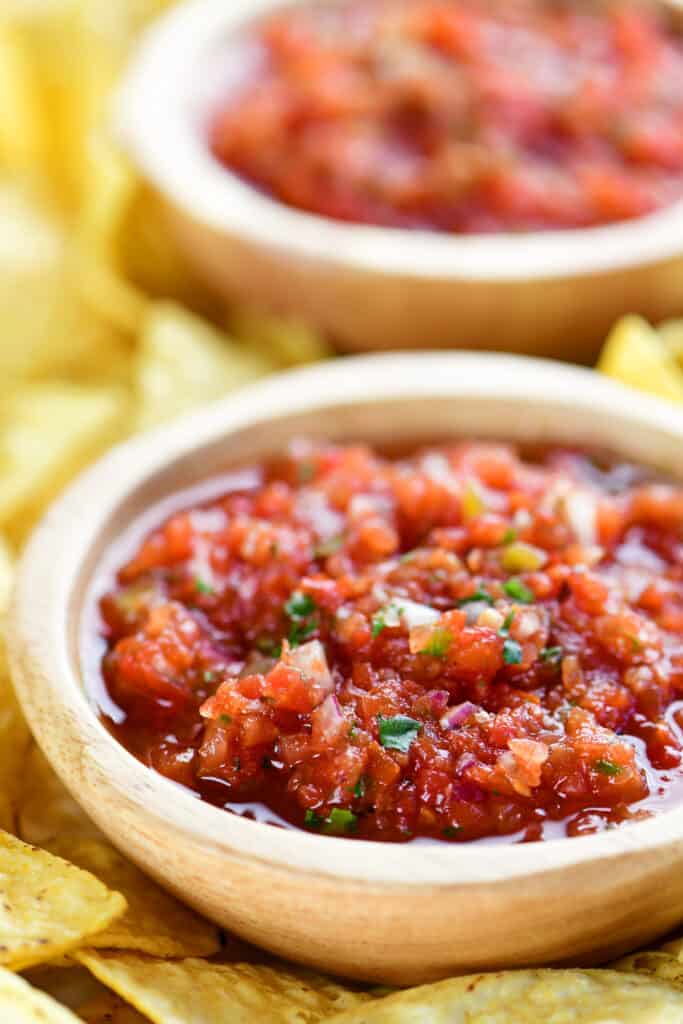 two bowls of salsa with chips