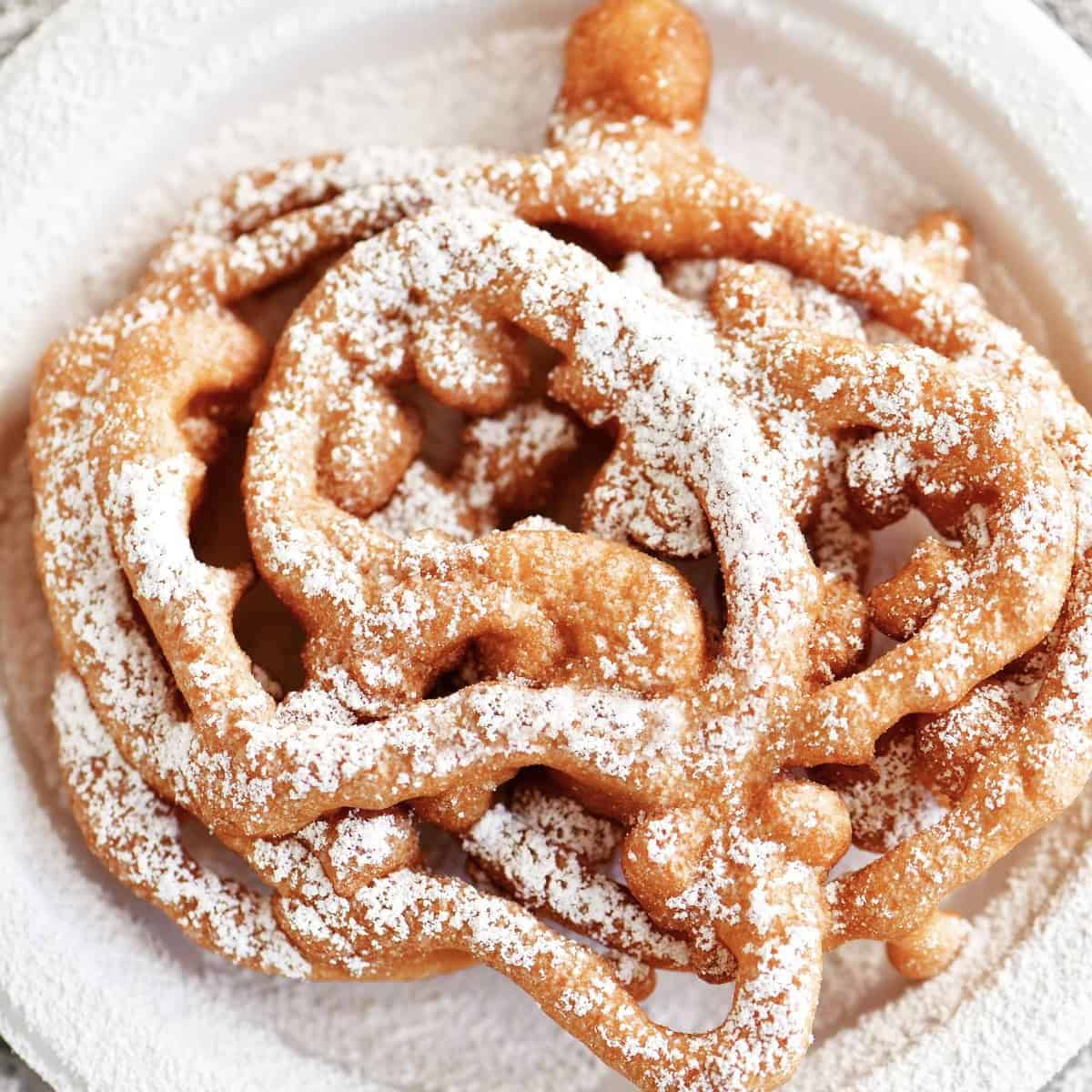 funnel cake on a white plate.