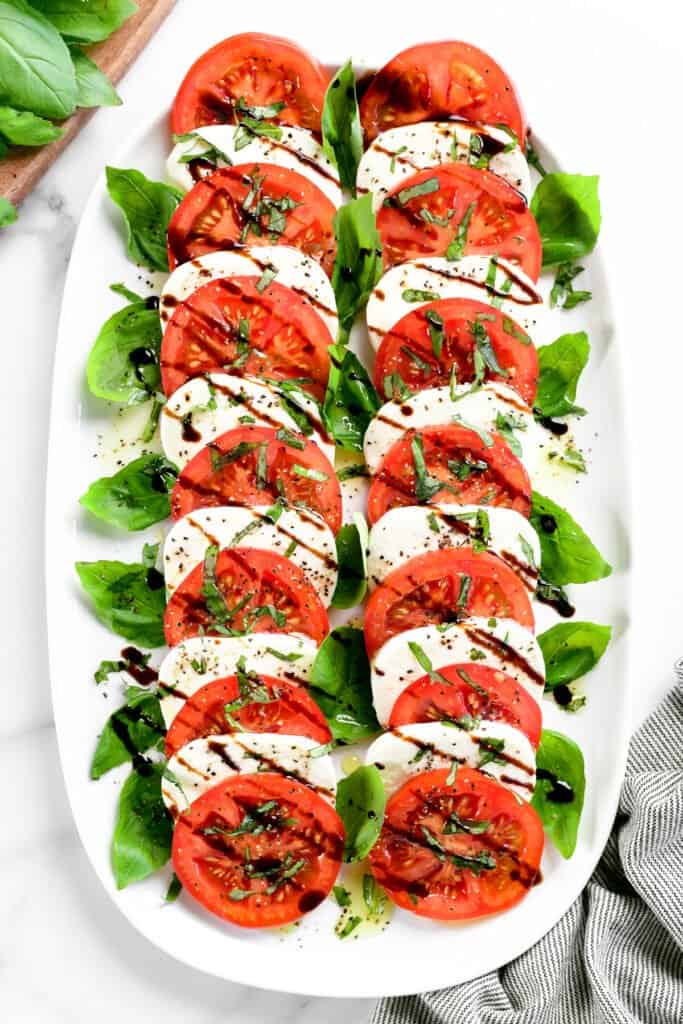 a caprese salad with balsamic vinegar and olive oil.