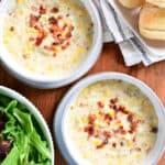 bread, salad and corn chowder in bowls.