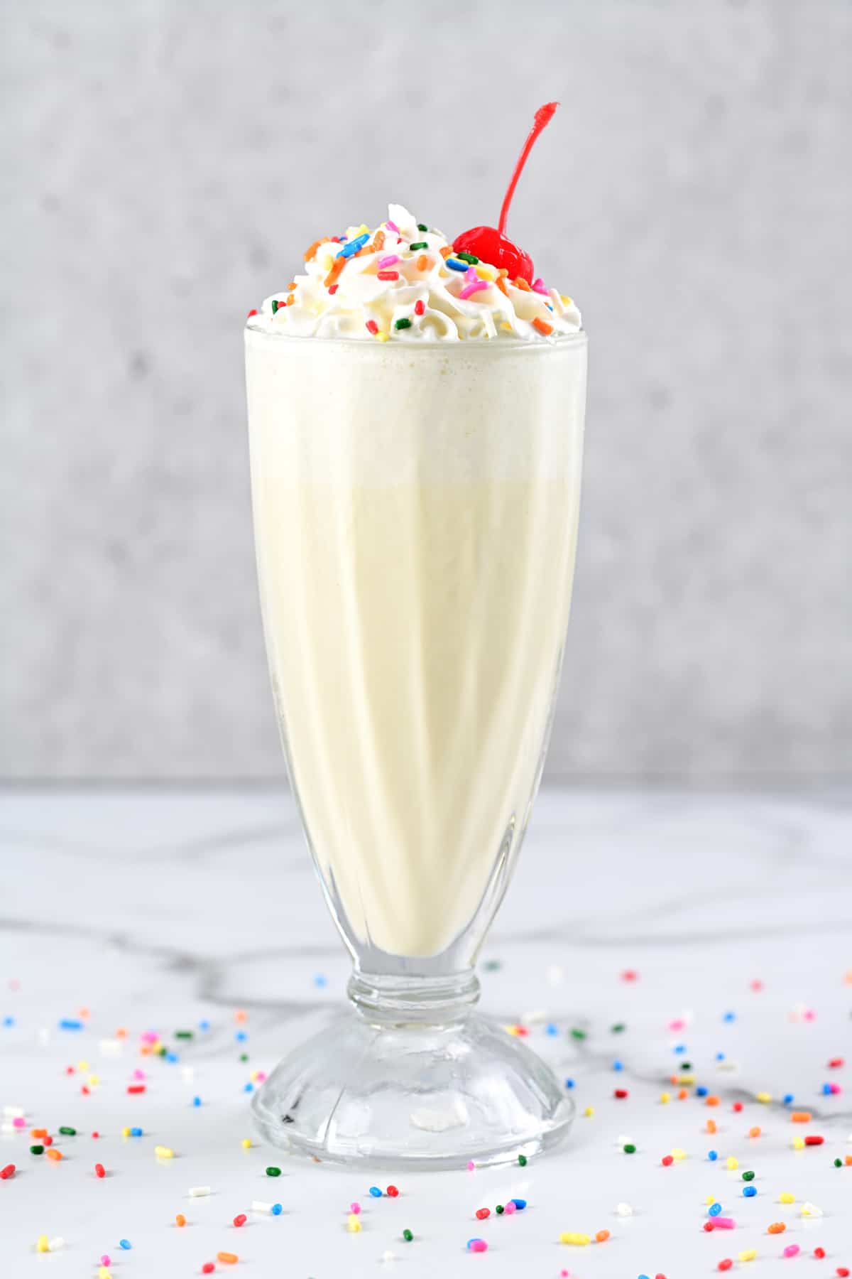 a vanilla milkshake in a glass.