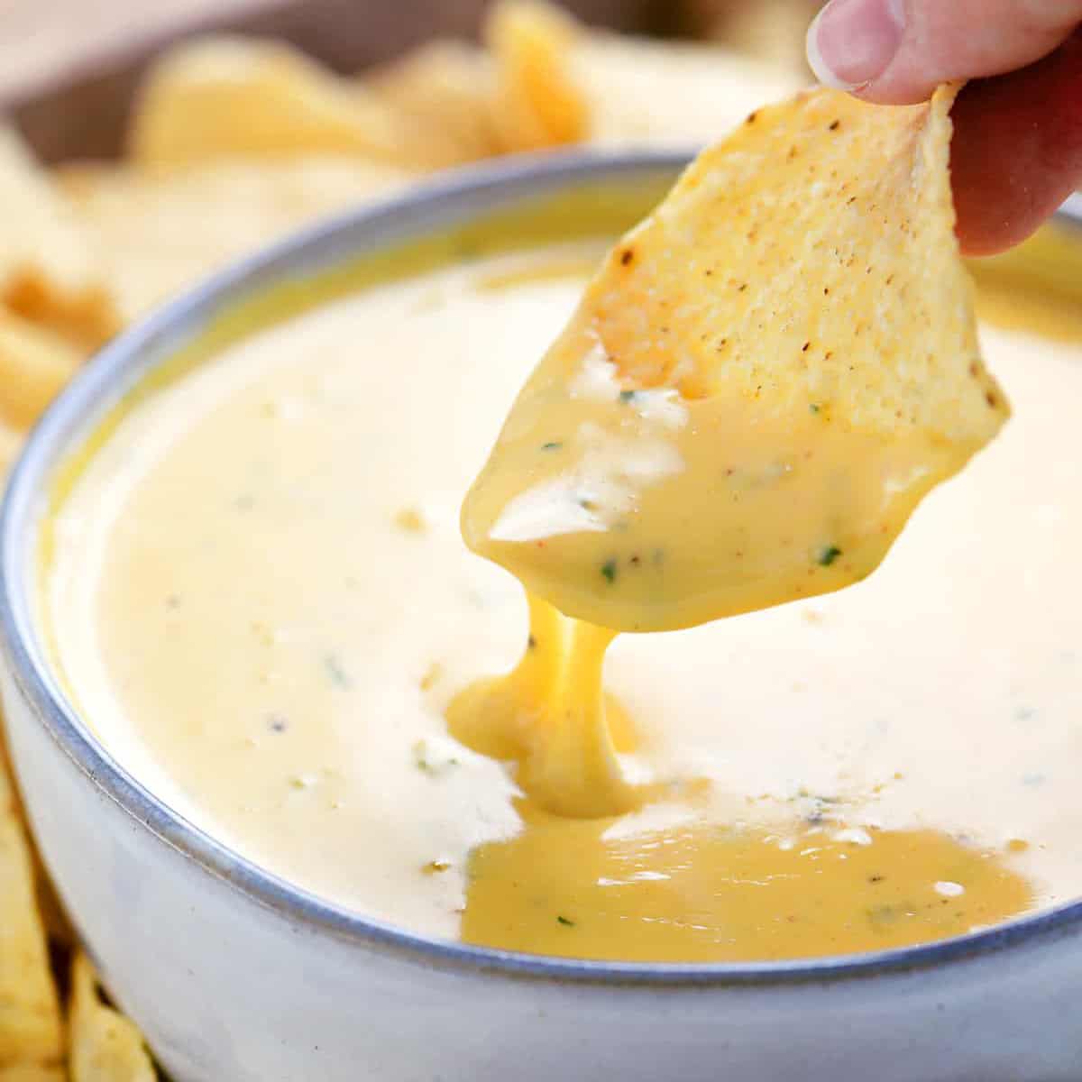 chip dipped in queso.