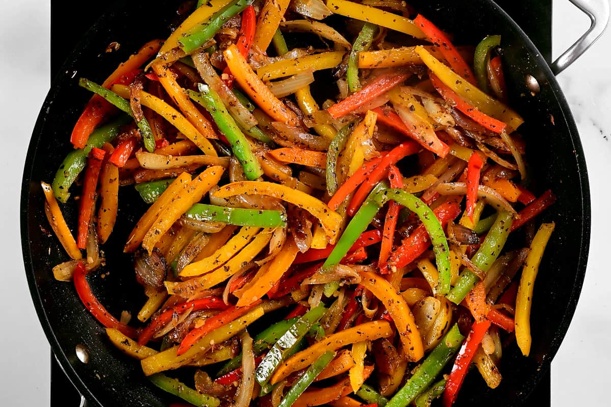 peppers frying in a pan.