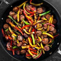peppers and sausage in a pan.