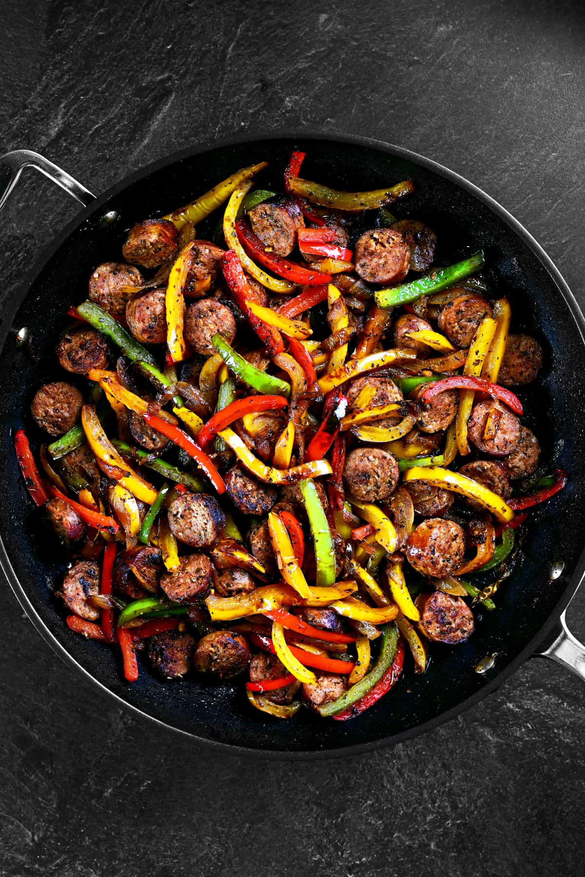 sausage and peppers in a pan.