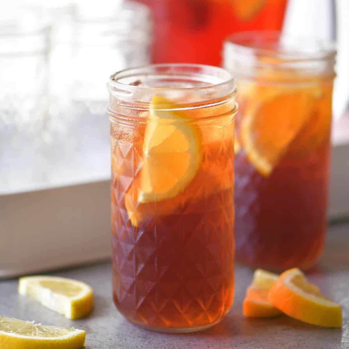 two glasses of sweet tea with slices of lemon.
