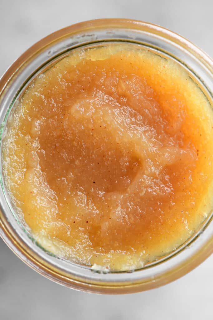 close up of the inside of a jar of applesauce.