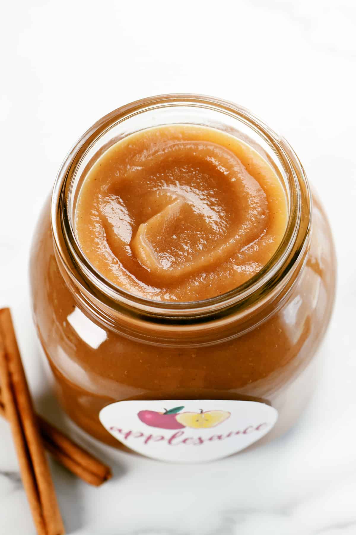 slow cooker applesauce in a mason jar with a label.