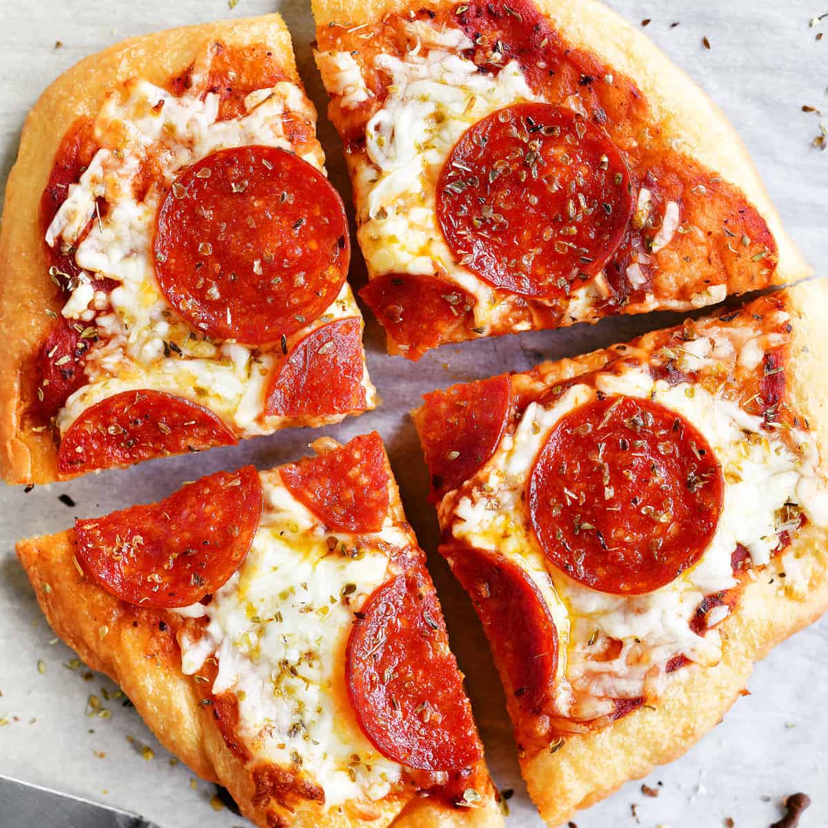 a small pepperoni pizza cut into four slices.