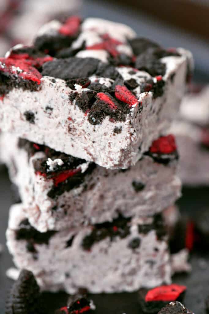 close up of pink peppermint oreo fudge in a stack.