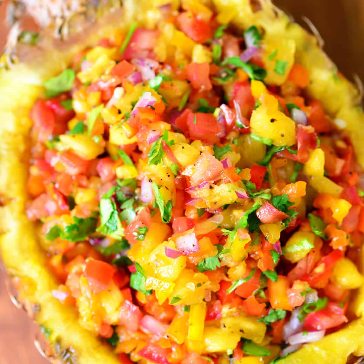 pineapple salsa in a pineapple bowl.