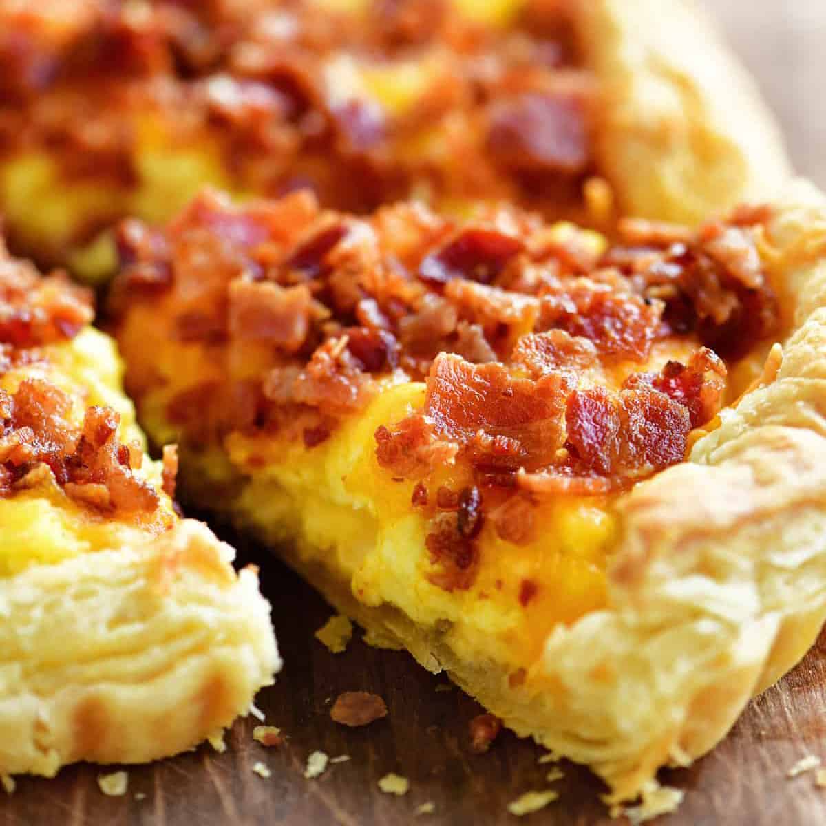 a slice of breakfast pizza with a puff pastry crust.