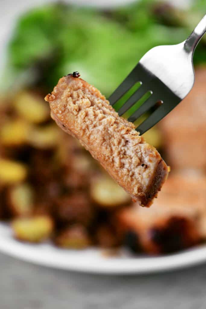 a sliced of meat on a fork.