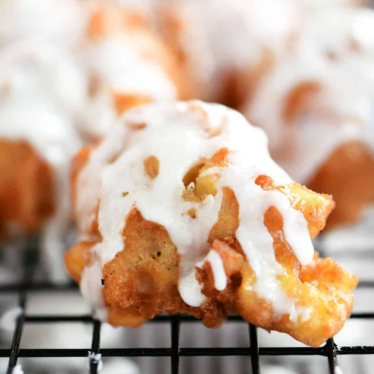 apple fritter bite with glaze on top.