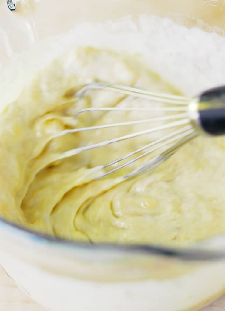 whisking batter in a bowl.
