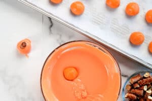 coating oreo balls with orange candy coating.