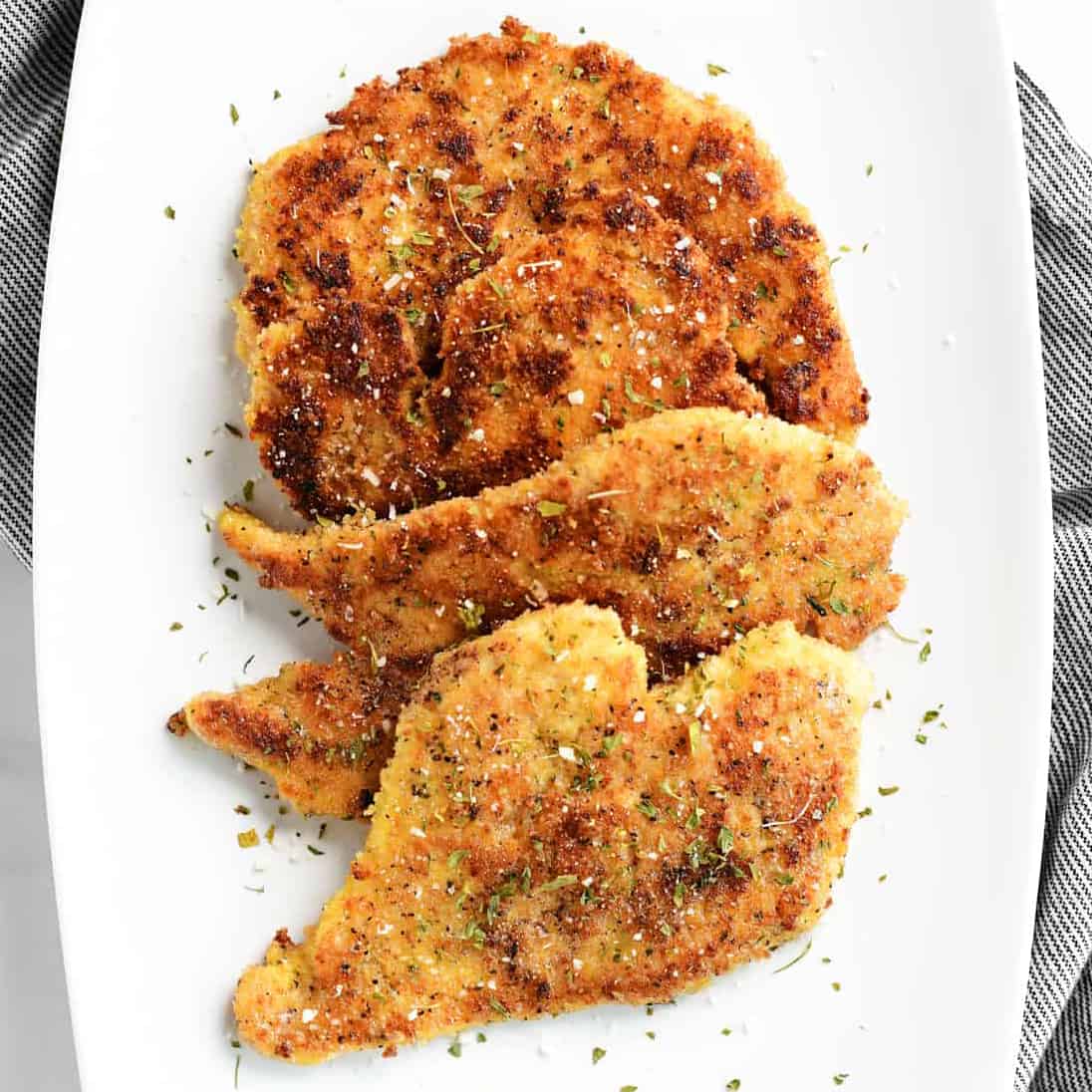 parmesan chicken on a white tray.