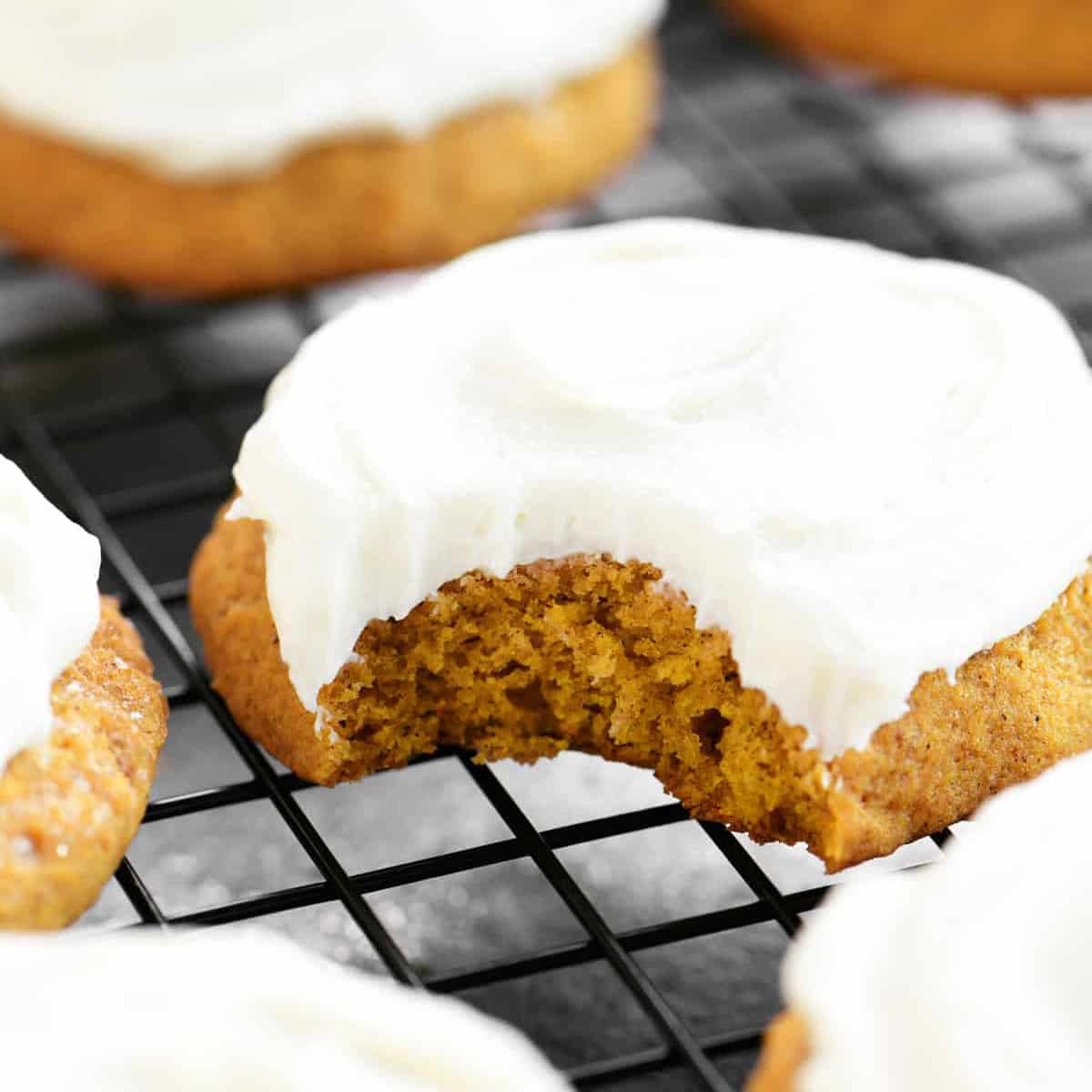 pumpkin cookies with cream cheese frosting on top.