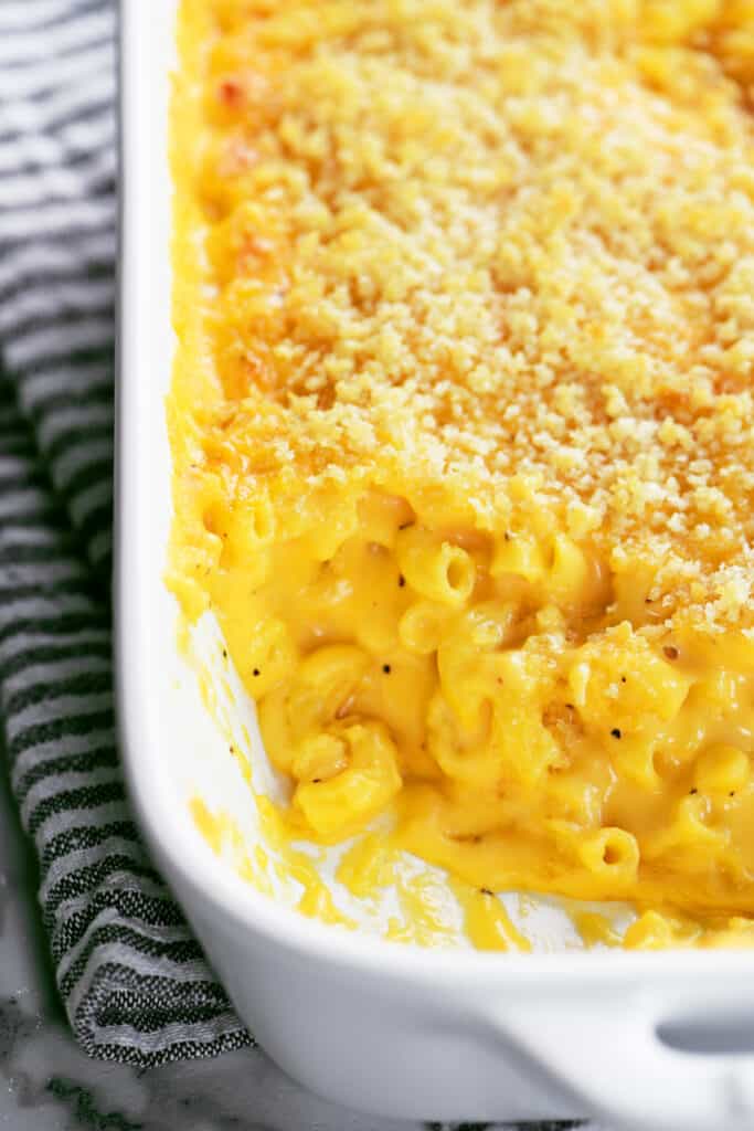 southern baked mac and cheese in a white casserole dish.