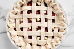 lattice crust on an unbaked cherry pie.