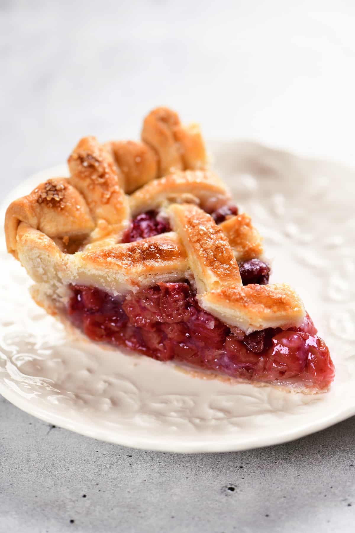 slice of cherry pie on a white plate.