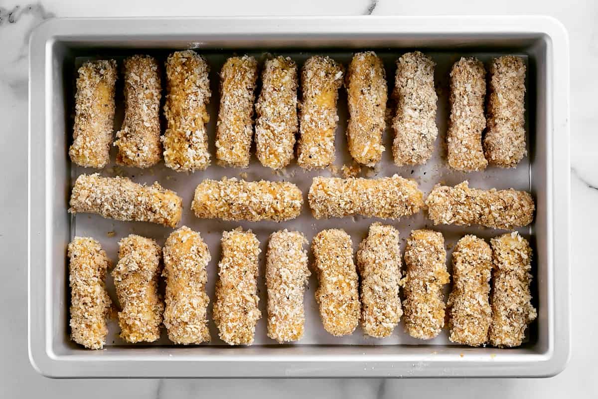 breaded cheese sticks in a freezer pan.