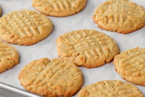 several peanut butter cookies on parchment paper.