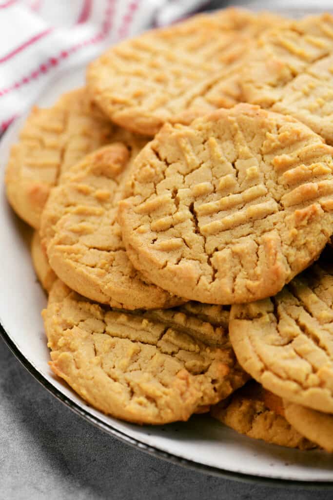 peanut butter cookies stacked on a plate.