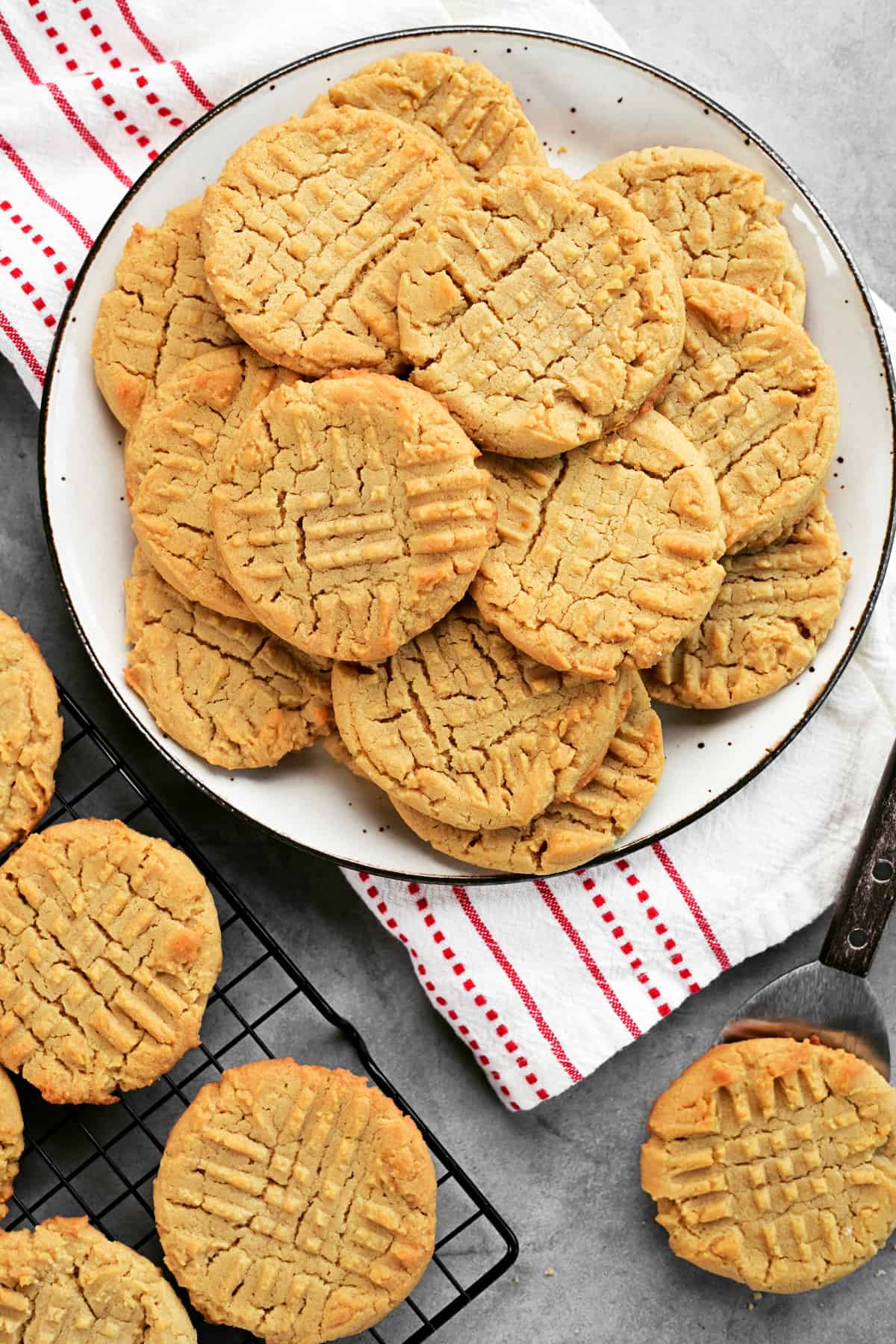 Peanut butter cookies on a rack and cookies on a plate.