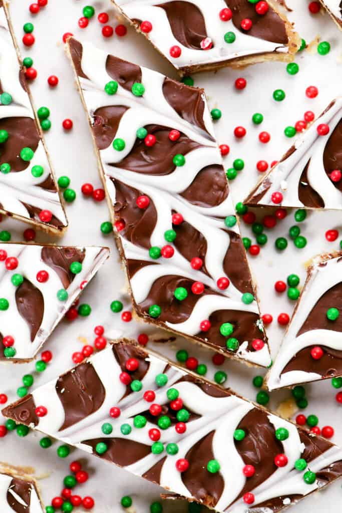 Christmas crack saltine cracker toffee pieces with red and green sprinkles on top.