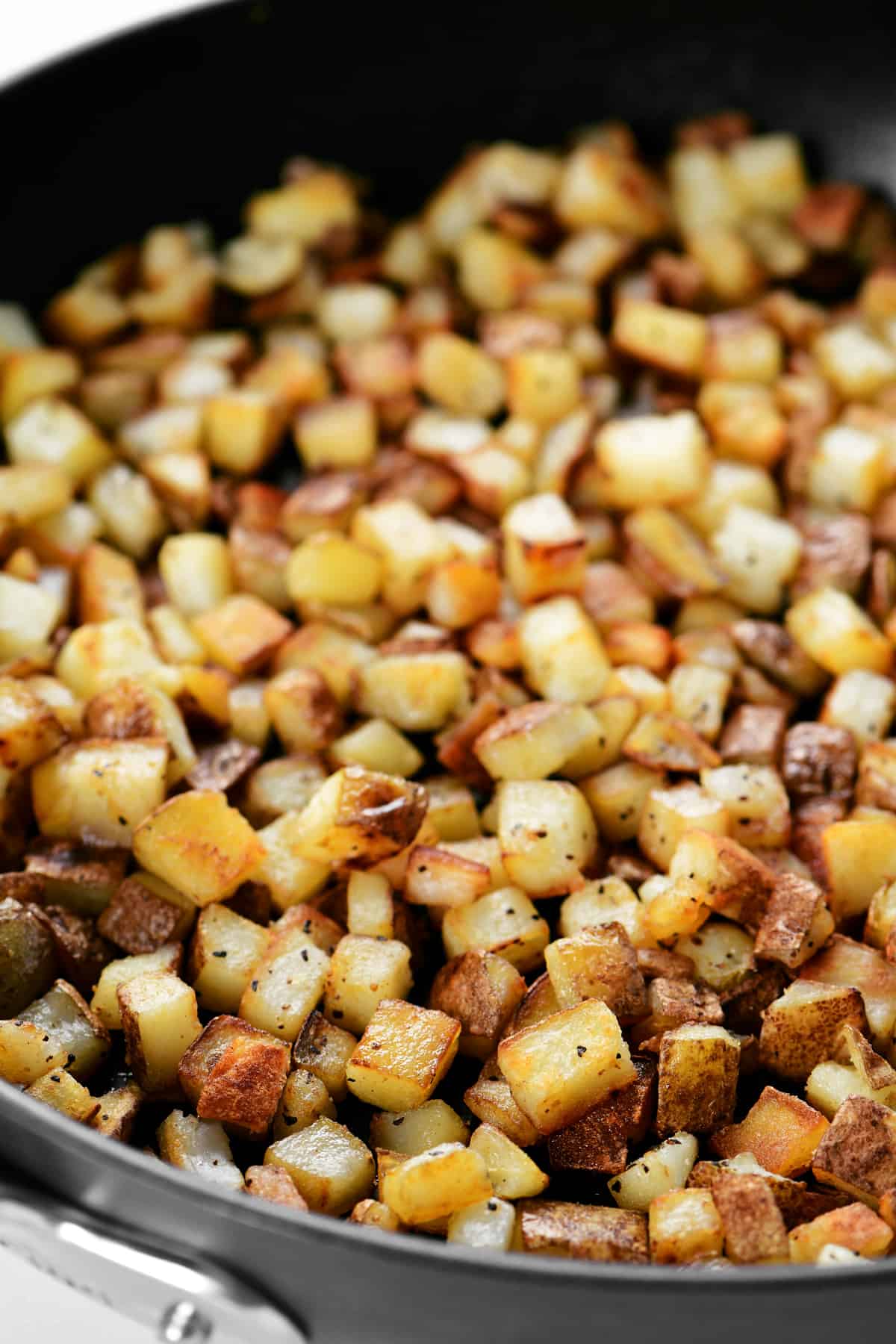 breakfast potatoes in a frying pan.