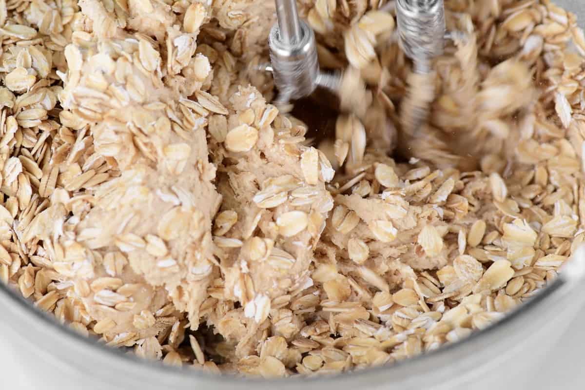 mixing rolled oats into cookie batter.