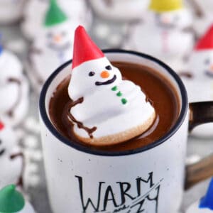 a meringue snowman in a cup of hot chocolate.