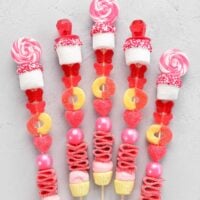 pink, red, yellow and white candies arranged on wooden kabob sticks.