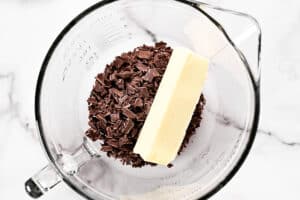 shaved chocolate and butter in a mixing bowl.