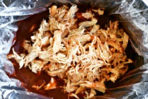 shredded chicken in bbq sauce in a slow cooker.