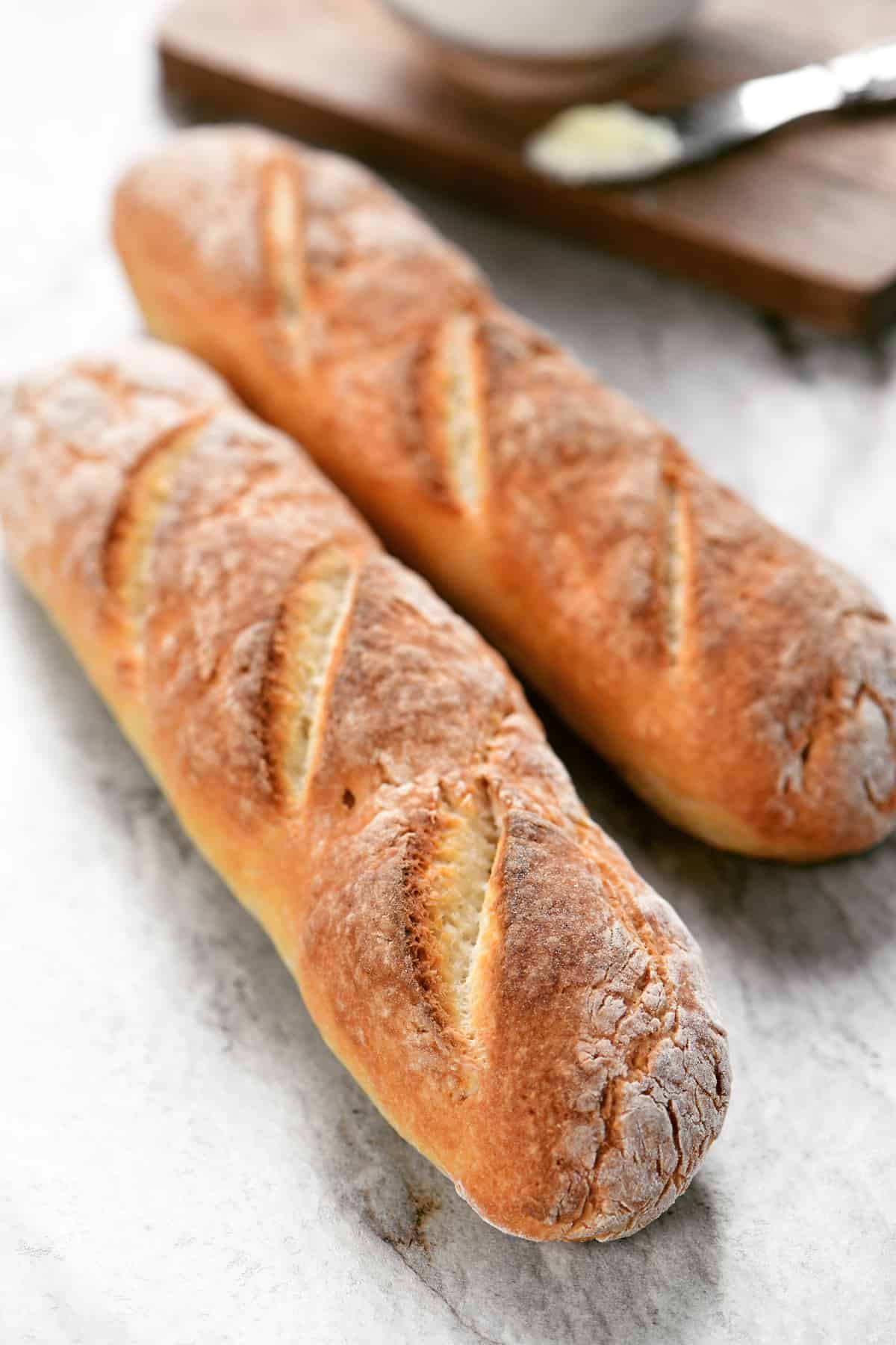 two ingredient dough baguettes resting on a countertop.